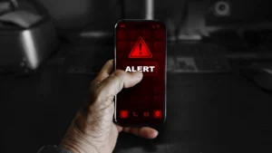 smartphone with multiple red warning icons displayed, symbolizing potential data breaches or cybersecurity alerts as featured on cloxmagazine